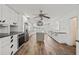 Modern kitchen with white cabinets, a center island, stainless steel appliances, and wood-style flooring at 6103 6Th Nw Ave, Bradenton, FL 34209
