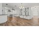 Spacious kitchen featuring a central island, wood floors, custom cabinets, and modern appliances at 6103 6Th Nw Ave, Bradenton, FL 34209