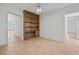 Living room with built in shelving and wood-look flooring at 6103 6Th Nw Ave, Bradenton, FL 34209