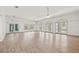 Living room with multiple windows, ceiling fans and wood-look flooring at 6103 6Th Nw Ave, Bradenton, FL 34209