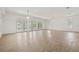 Living room with multiple windows, ceiling fans and wood-look flooring at 6103 6Th Nw Ave, Bradenton, FL 34209