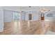 Open-concept living space with wood floors, large window, and entryway to a room with a wood door at 6103 6Th Nw Ave, Bradenton, FL 34209