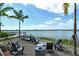 Community space near the lake with comfortable seating and views of the calm lake and tropical landscaping at 6204 Isla Del Ray Ave, Sarasota, FL 34240