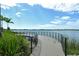 Curving walking path along the lake with lush greenery and views of the calm water at 6204 Isla Del Ray Ave, Sarasota, FL 34240