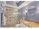 Updated bathroom with tile shower, glass door, granite countertop, offering a modern and stylish design at 6472 Seagull Dr # 301, Bradenton, FL 34210