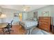 Comfortable bedroom features a ceiling fan, wood floors, and natural light at 6472 Seagull Dr # 301, Bradenton, FL 34210