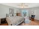 Inviting bedroom with comfortable bed, ceiling fan, and access to the enclosed lanai at 6472 Seagull Dr # 301, Bradenton, FL 34210
