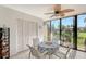 Bright enclosed lanai features dining set, ceiling fan and beautiful exterior views at 6472 Seagull Dr # 301, Bradenton, FL 34210
