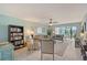 Bright living room with tile floors, ceiling fan, comfortable seating, and access to a screened lanai at 6472 Seagull Dr # 301, Bradenton, FL 34210