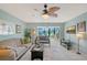 Inviting living room with a ceiling fan, large windows with natural light, and a decorative rug at 6472 Seagull Dr # 301, Bradenton, FL 34210