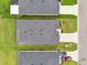 Aerial view of three homes showing roof style, landscaping, and concrete driveways at 6528 166Th E Pl, Parrish, FL 34219