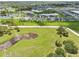 Aerial shot shows houses and ponds are arranged in an open, green landscape, with roads connecting the neighborhood at 6528 166Th E Pl, Parrish, FL 34219