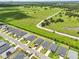 Aerial view of homes in a neighborhood nestled within lush green landscapes and ponds at 6528 166Th E Pl, Parrish, FL 34219