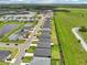 An expansive aerial view captures homes lining the street next to verdant fields with ponds at 6528 166Th E Pl, Parrish, FL 34219
