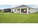 Lush backyard featuring a covered patio, well-maintained lawn, and inviting outdoor space at 6528 166Th E Pl, Parrish, FL 34219
