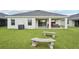 Expansive backyard with a lush green lawn, patio, and peaceful surroundings, perfect for outdoor activities at 6528 166Th E Pl, Parrish, FL 34219