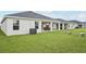 Spacious backyard with a covered patio, lush lawn, and serene surroundings at 6528 166Th E Pl, Parrish, FL 34219
