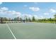 Community basketball court with fencing and trees in the background at 6528 166Th E Pl, Parrish, FL 34219
