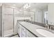 Modern bathroom features dual sinks, marble tile, and a glass enclosed shower at 6528 166Th E Pl, Parrish, FL 34219