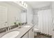 Bright bathroom featuring double sinks, quartz counters, tile backsplash, and tiled shower at 6528 166Th E Pl, Parrish, FL 34219