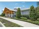 Exterior of the community building showcasing landscaping, modern design and walkway at 6528 166Th E Pl, Parrish, FL 34219