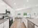 Modern kitchen featuring a dining nook, stainless steel appliances, and luxury vinyl plank flooring at 6528 166Th E Pl, Parrish, FL 34219