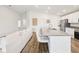 Modern kitchen featuring a large island with bar stool seating and stainless steel appliances at 6528 166Th E Pl, Parrish, FL 34219