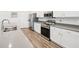 Well-lit kitchen featuring stainless steel appliances, gray countertops, and white cabinets at 6528 166Th E Pl, Parrish, FL 34219