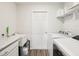 Well-organized laundry room with modern washer and dryer, ample counter space, and shelving at 6528 166Th E Pl, Parrish, FL 34219