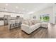 Spacious living room with modern decor, luxury vinyl plank flooring, and an open-concept layout at 6528 166Th E Pl, Parrish, FL 34219