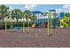 Community playground with slides and swings with safety ground covering at 6528 166Th E Pl, Parrish, FL 34219