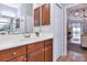 Bathroom with a vanity, neutral walls, modern lighting, and a view of the backyard from the doorway at 6845 74Th Street E Cir, Bradenton, FL 34203