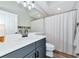 Bathroom featuring a white vanity, sink, mirror, shower with curtain, and light gray walls at 6845 74Th Street E Cir, Bradenton, FL 34203