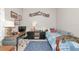 Bedroom featuring a desk, TV, full-sized bed, a rug, and a mounted 'Welcome to the Ranch' sign at 6845 74Th Street E Cir, Bradenton, FL 34203