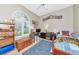 Bedroom with neutral walls, wood floors, and a window letting in lots of natural light overlooking the front yard at 6845 74Th Street E Cir, Bradenton, FL 34203
