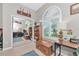 Bright bedroom with a wooden chest, built-in shelving, a modern desk, and a window with shutter-style blinds at 6845 74Th Street E Cir, Bradenton, FL 34203