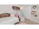 Cozy bedroom with wooden bed frame, dresser, and closet doors accented by floral and decorative elements at 6845 74Th Street E Cir, Bradenton, FL 34203