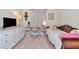 A brightly lit bedroom that features a desk, dresser, bed and a pink rug at 6845 74Th Street E Cir, Bradenton, FL 34203