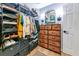 Large walk-in closet featuring metal shelving, drawers, and a small dresser for accessories and storage at 6845 74Th Street E Cir, Bradenton, FL 34203
