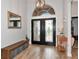 A bright foyer features stylish tile flooring, a decorative light fixture, and a transom window at 6845 74Th Street E Cir, Bradenton, FL 34203
