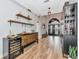 Inviting foyer featuring wood-look tile floors, storage, and bar area with views of the front doors at 6845 74Th Street E Cir, Bradenton, FL 34203