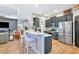 Modern kitchen features an island with seating, stainless steel appliances, and pendant lighting at 6845 74Th Street E Cir, Bradenton, FL 34203