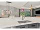 Bright kitchen features granite countertops, stainless steel sink, and pendant lighting at 6845 74Th Street E Cir, Bradenton, FL 34203