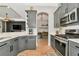 Stylish kitchen featuring grey cabinets, stainless steel appliances, and an open layout at 6845 74Th Street E Cir, Bradenton, FL 34203