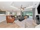 Open-concept living room with access to the outdoor patio and a view of the kitchen at 6845 74Th Street E Cir, Bradenton, FL 34203
