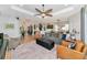 Spacious living room with modern furniture, a ceiling fan, and an open floor plan at 6845 74Th Street E Cir, Bradenton, FL 34203