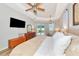 Spacious bedroom with tray ceilings, a ceiling fan, an entertainment center, and sliding glass doors to the backyard at 6845 74Th Street E Cir, Bradenton, FL 34203