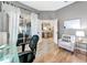 Cozy office space with a white chair, white curtains, and views into the living room and screened-in patio at 6845 74Th Street E Cir, Bradenton, FL 34203