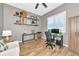 An office with wood-look flooring, a white chair, two desks, a window, and decorative shelving at 6845 74Th Street E Cir, Bradenton, FL 34203
