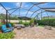 Enclosed patio with multiple seating areas and a small fire pit, perfect for outdoor entertaining and relaxation at 6845 74Th Street E Cir, Bradenton, FL 34203